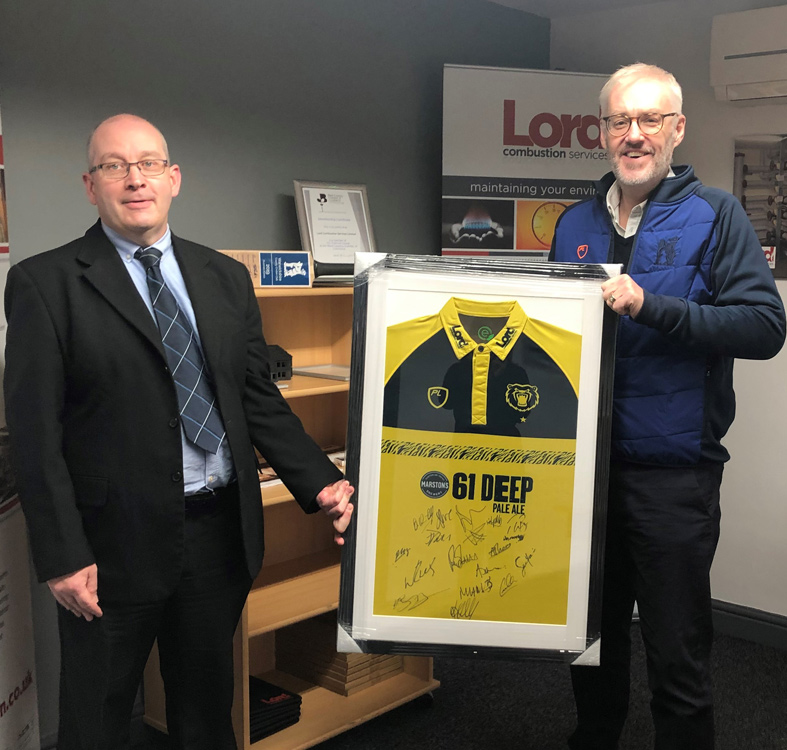 Warwickshire County Cricket Club chief executive Stuart Cain (right) presents the signed Birmingham Bears T20 shirt to Lord Combustion Services managing director Stuart Smith
